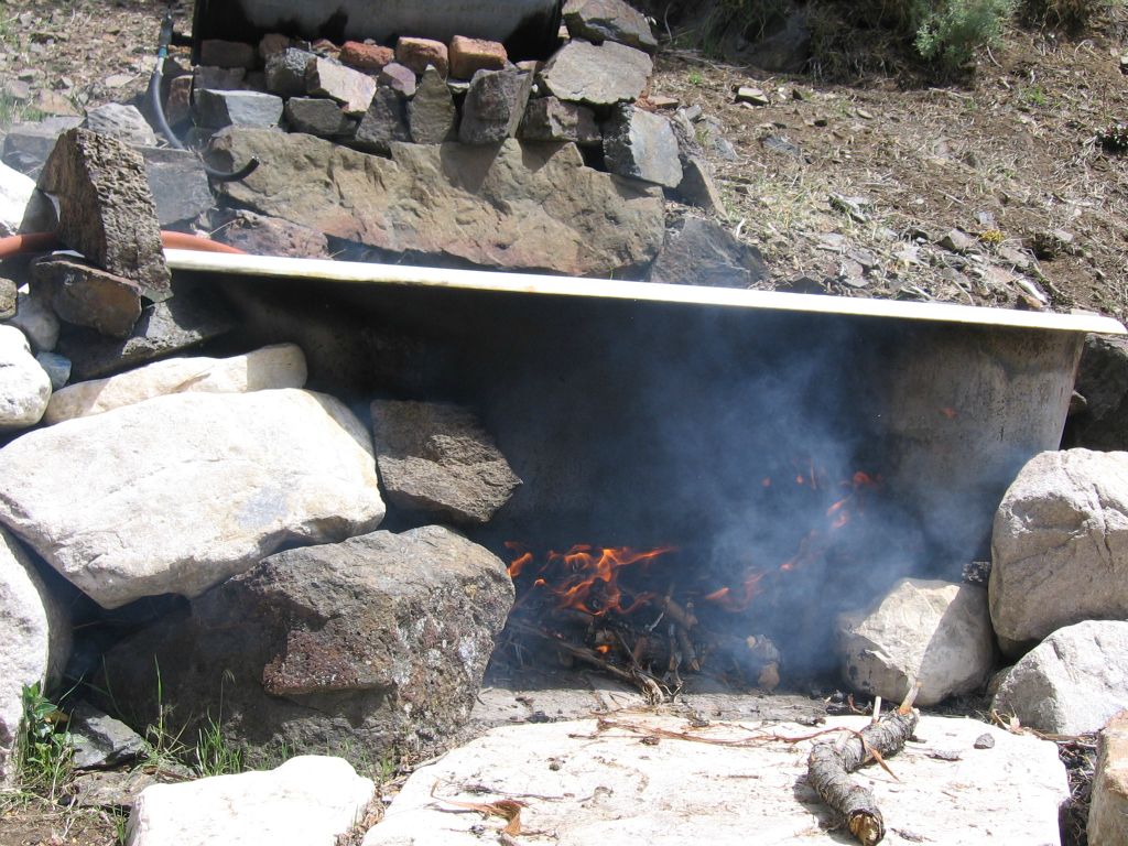 Over in Sourdough Canyon, Rob and Josh were heating the water in the outdoor bathtub: